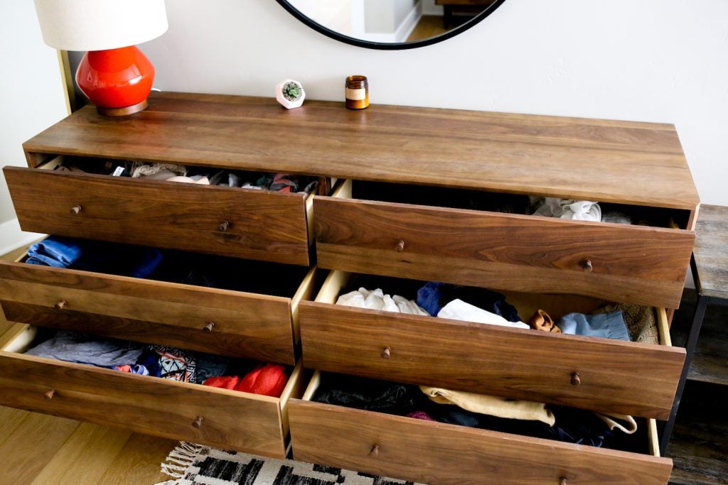 Clothing in Room and Board walnut dresser