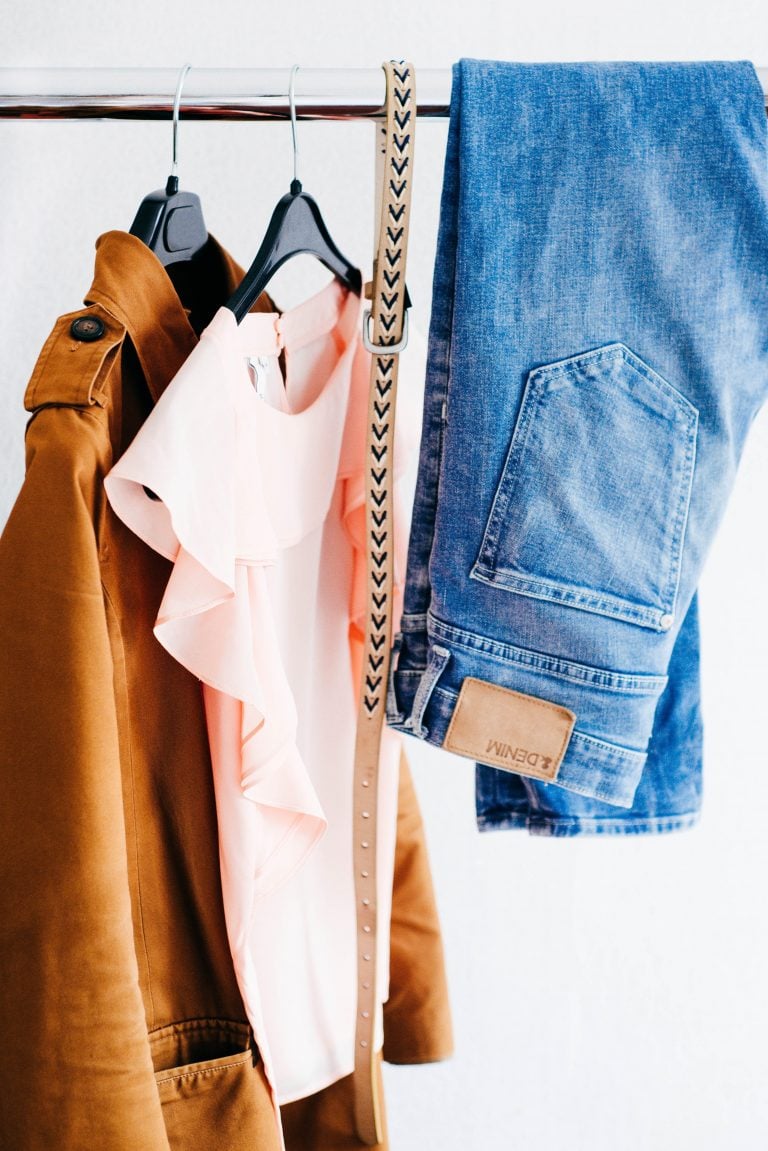 capsule wardrobe simple womens clothes hanging on rack