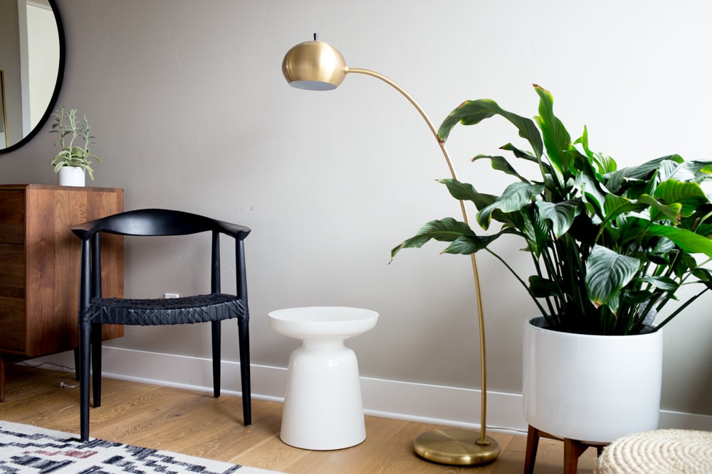 west elm modern planter lamp and white side table with black armchair