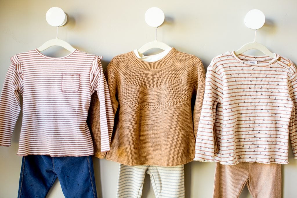 closeup of kids girls capsule wardrobe 3 outfits on hangers