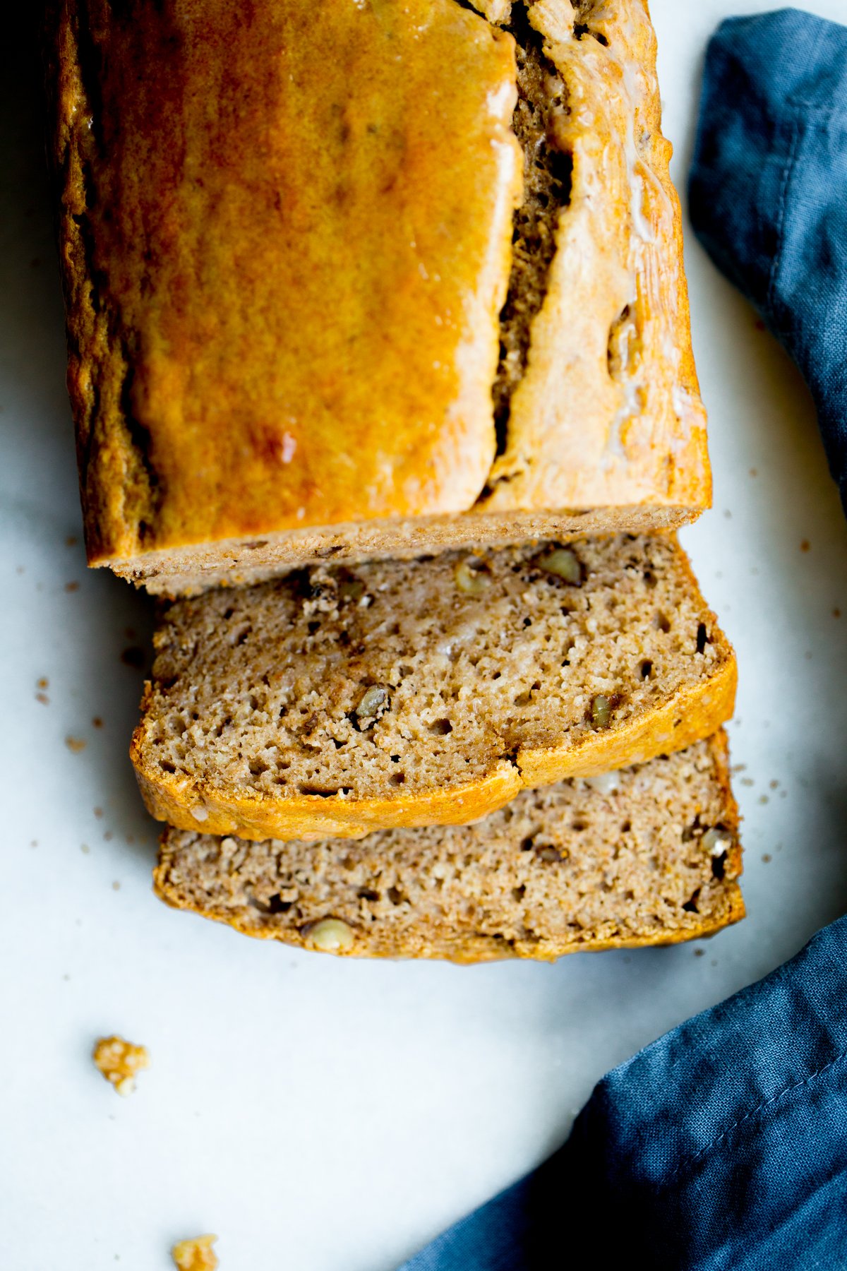 overhead photo of a loaf of healthy no added sugar banana bread with two slices cut