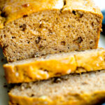 close up photo of a loaf of healthy no added sugar banana bread with two slices cut