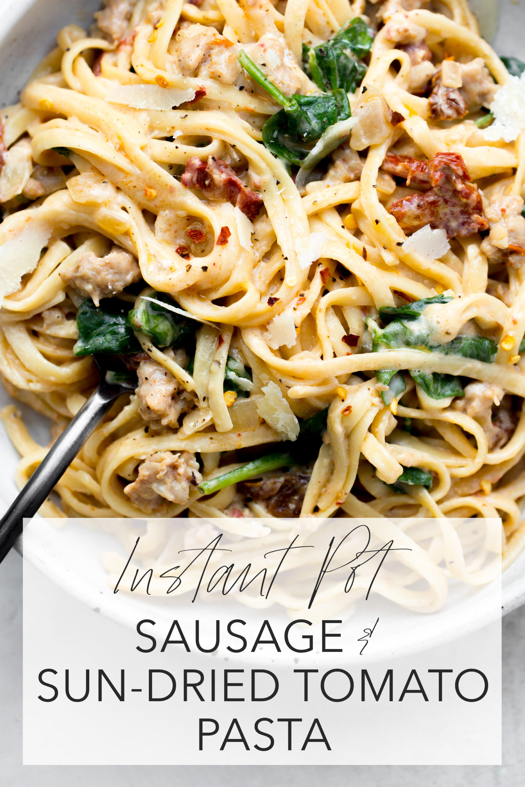 instant pot sausage sun-dried tomato pasta overhead in a gray bowl with title text overlay