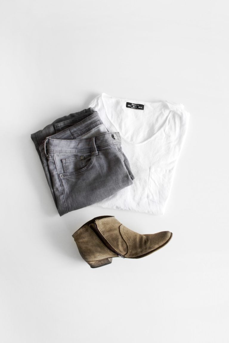 overhead flatlay of womens minimalist clothing on white background
