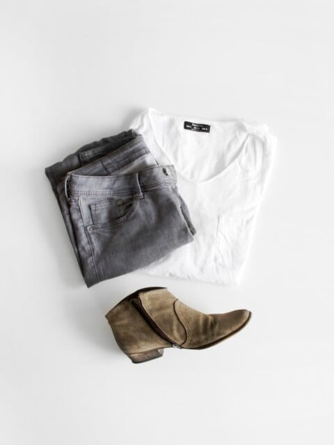 overhead flatlay of womens minimalist clothing on white background