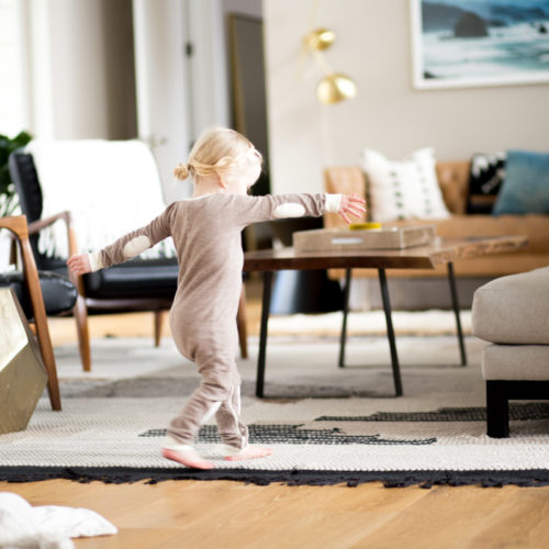 small girl dancing in modern living room