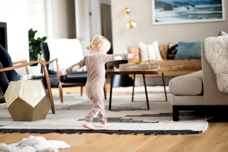 small girl dancing in modern living room