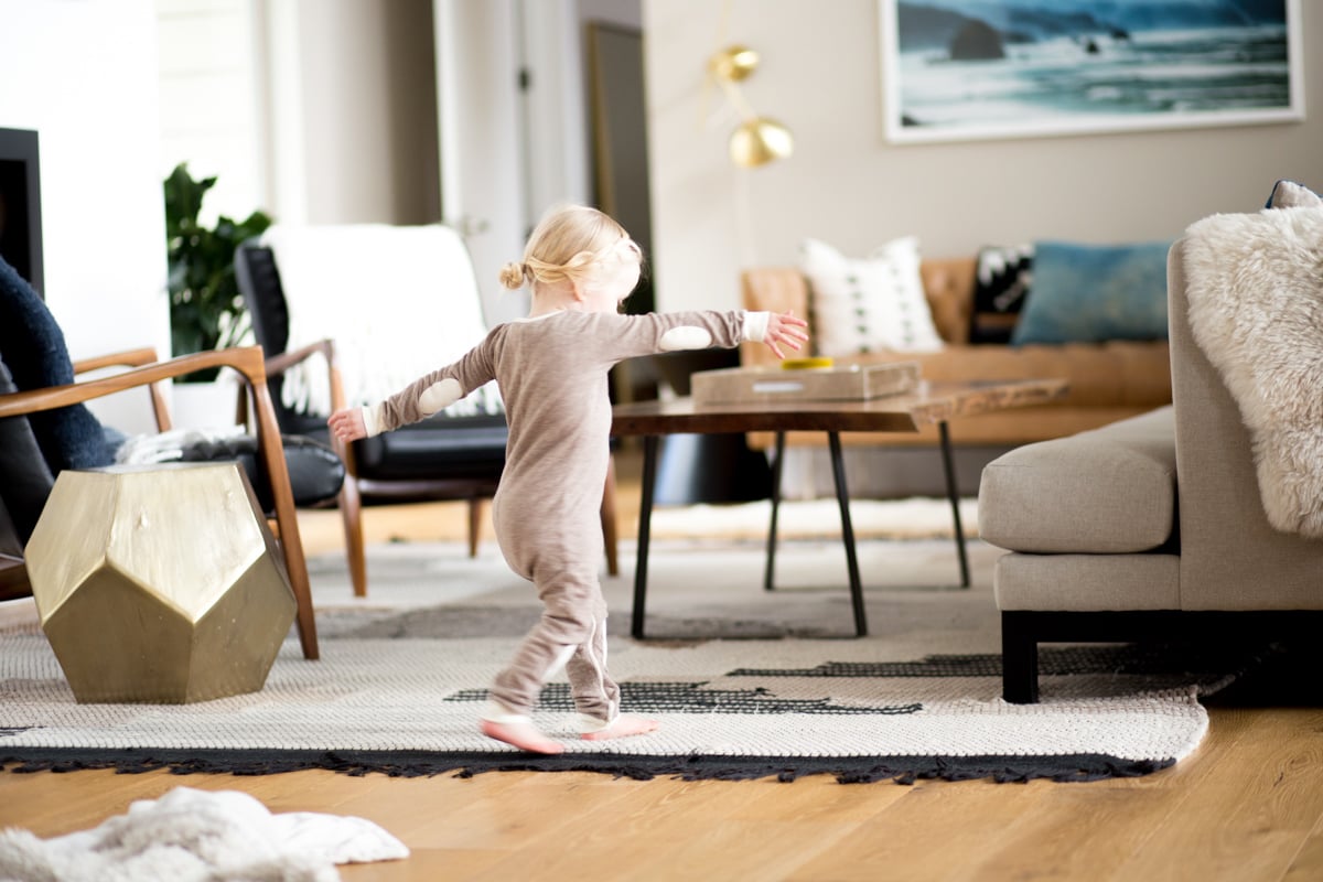 small girl dancing at home in pajamas