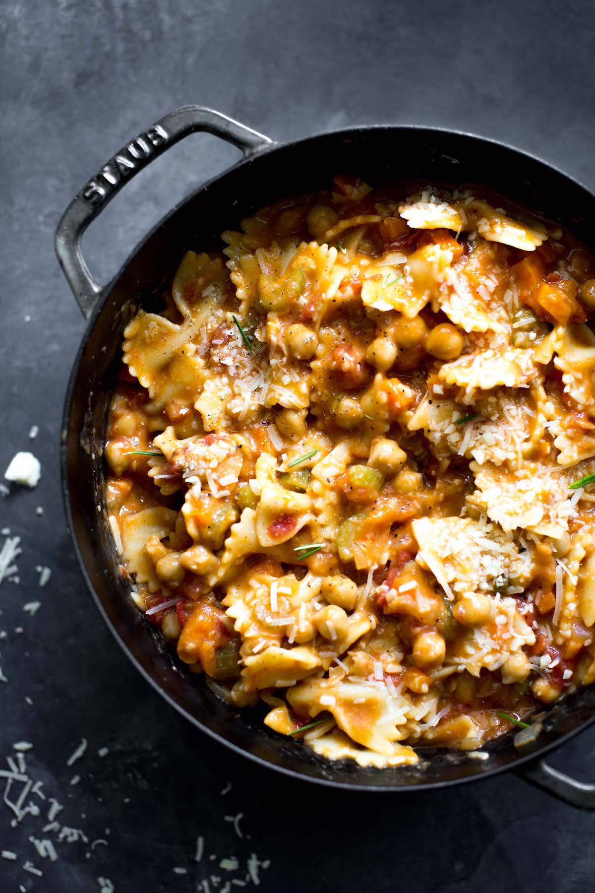 overhead photo of vegetarian pasta e ceci (pasta and chickpeas) in a big pot with dark gray background