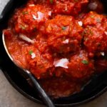 overhead photo of italian instant pot meatballs in marinara sauce in a cast iron skillet