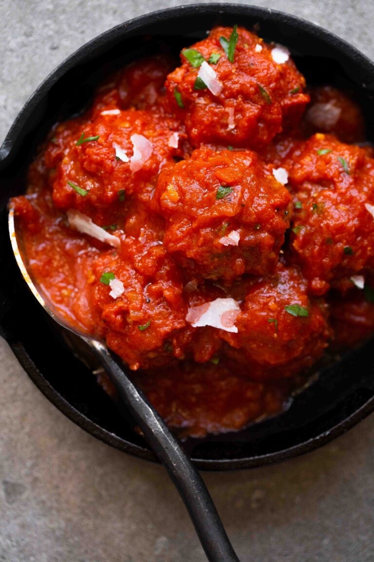 overhead photo of italian instant pot meatballs in marinara sauce in a cast iron skillet
