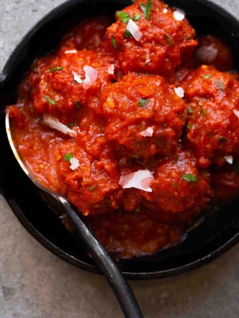 overhead photo of italian instant pot meatballs in marinara sauce in a cast iron skillet
