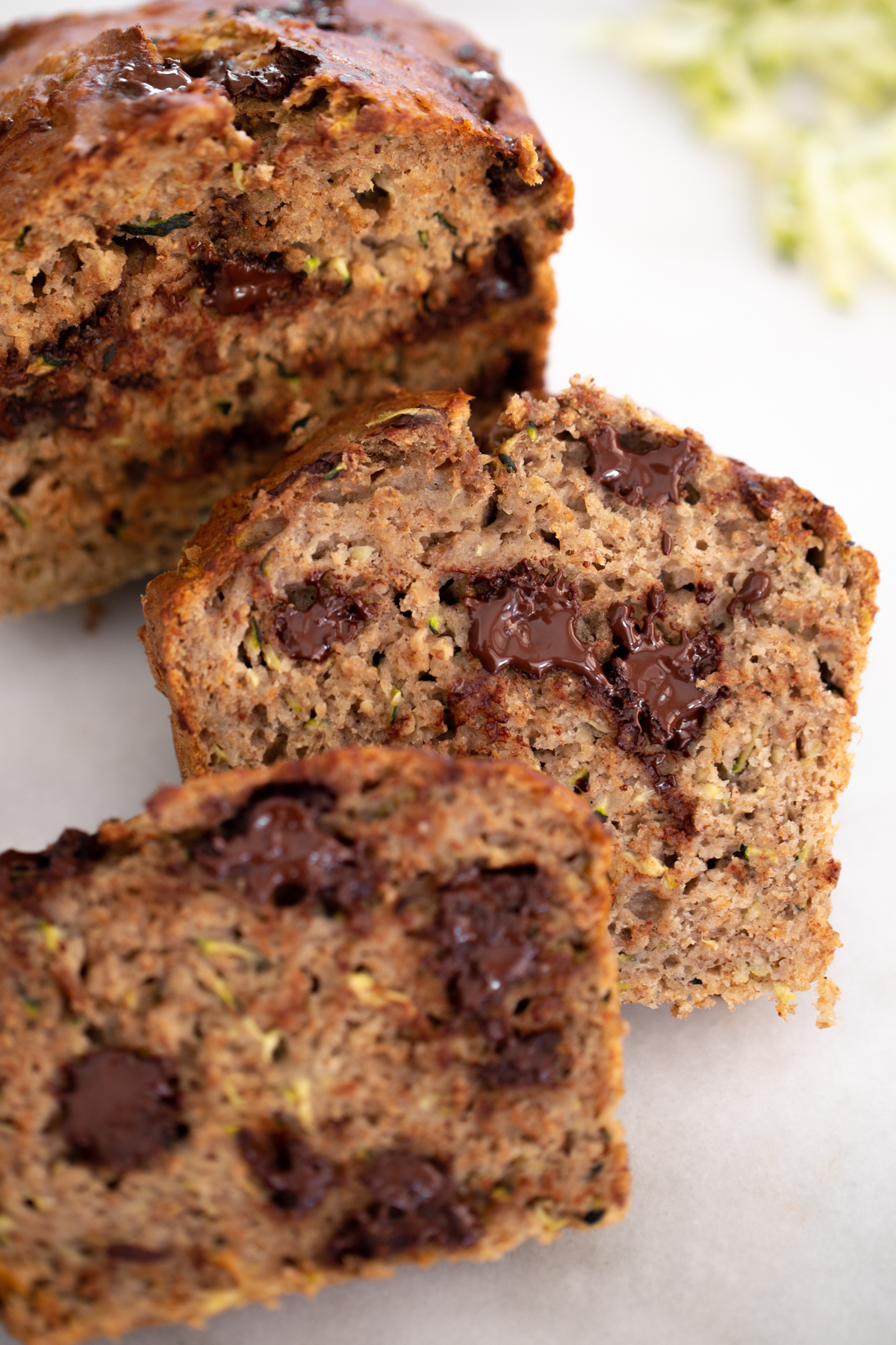 Closeup photo of sliced healthy zucchini banana bread with melted chocolate chips